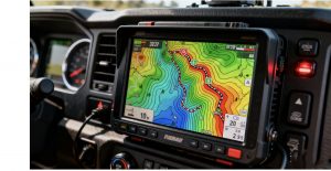 Fully installed off-road navigation display in a 4x4 truck dashboard, showing detailed topographic maps.