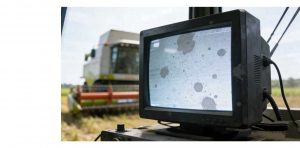 Close-up of a ruggedized industrial control panel display showing a small, faint grey spot on phone screen defect, highlighting the critical nature of industrial display module defects in operational settings.